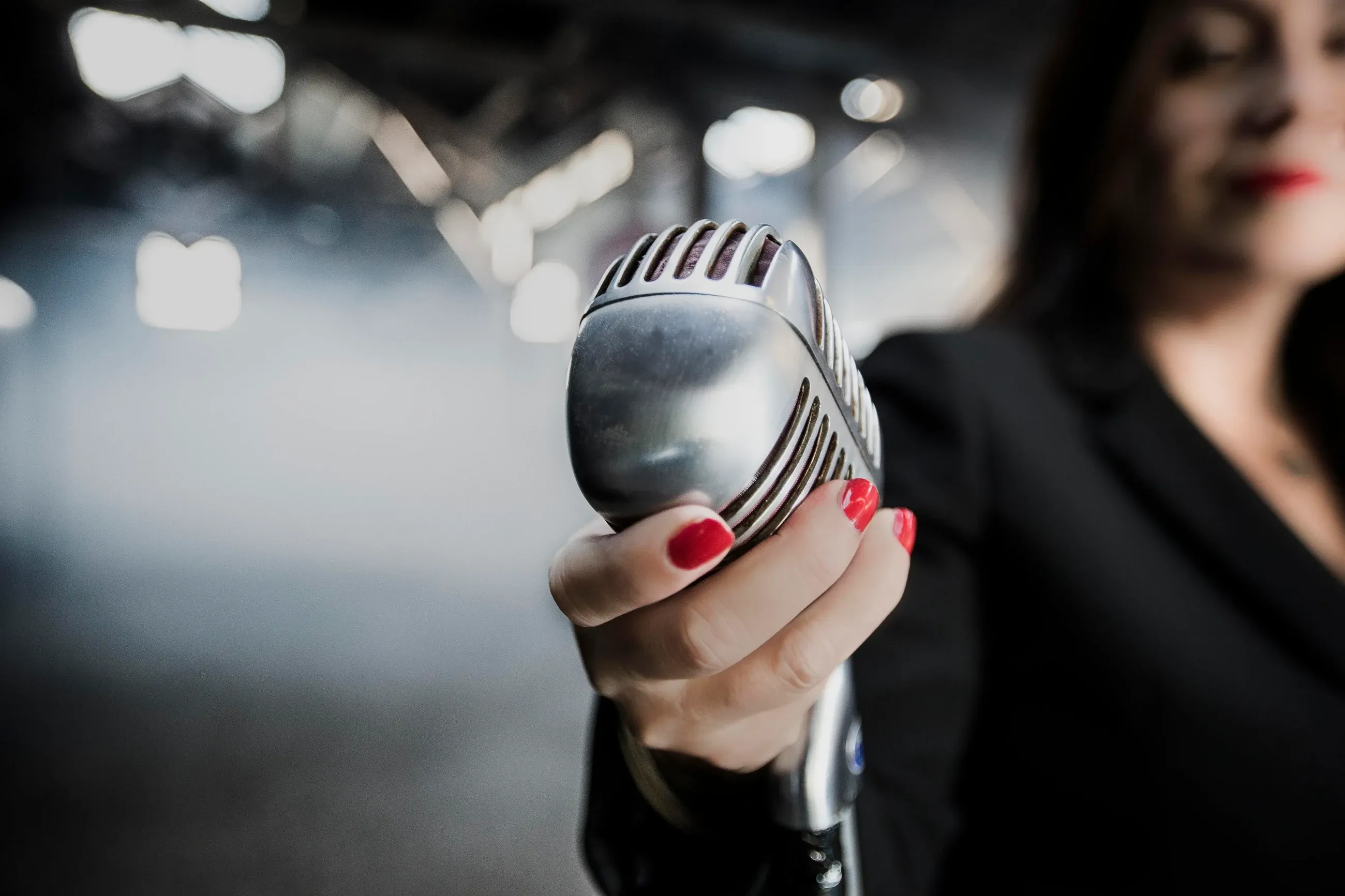Estelle Hubert holding a vintage microphone, a guide to becoming a professional voice actor