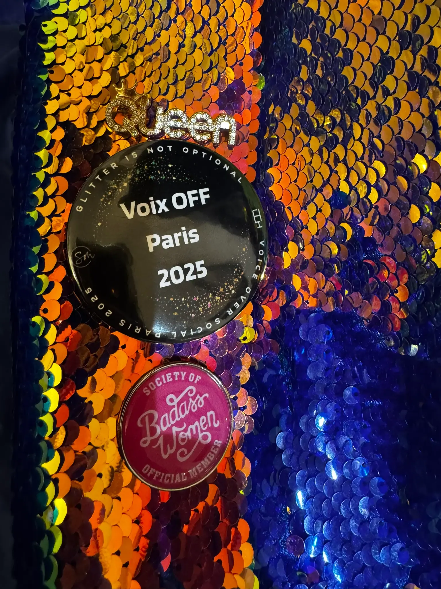 A “Voix OFF Paris 2025” badge pinned to Estelle Hubert’s sequinned jacket at VO Social Paris