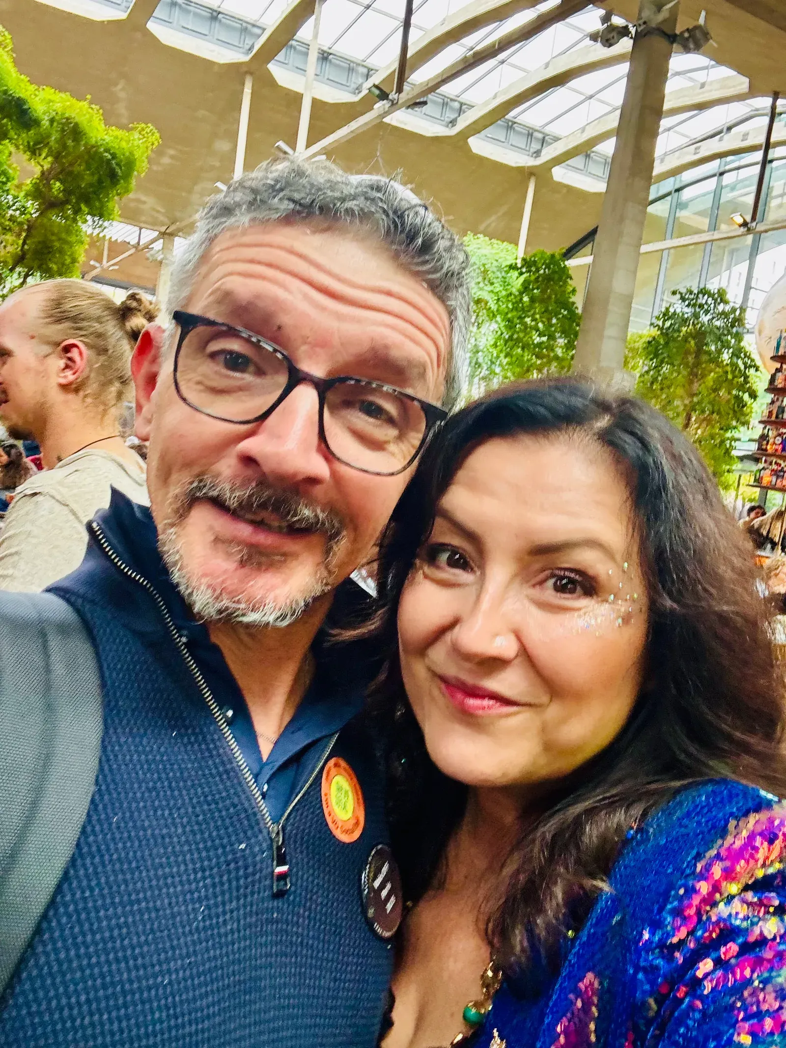 Estelle Hubert and voice actor Jeff Chaulange taking a selfie beneath La Felicità’s glass roof at VO Social Paris 2025