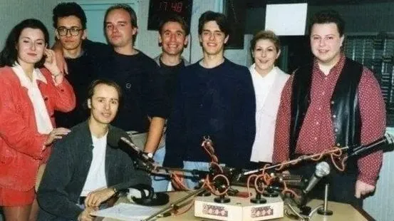 The Radio 2000 team in the studio around the mixing desk and microphones