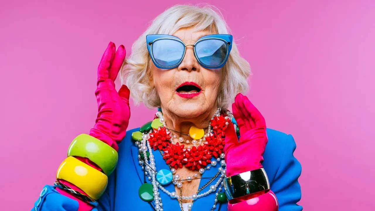 An eccentric grandmother with blue glasses and colourful jewellery, one of the demo’s e-learning characters