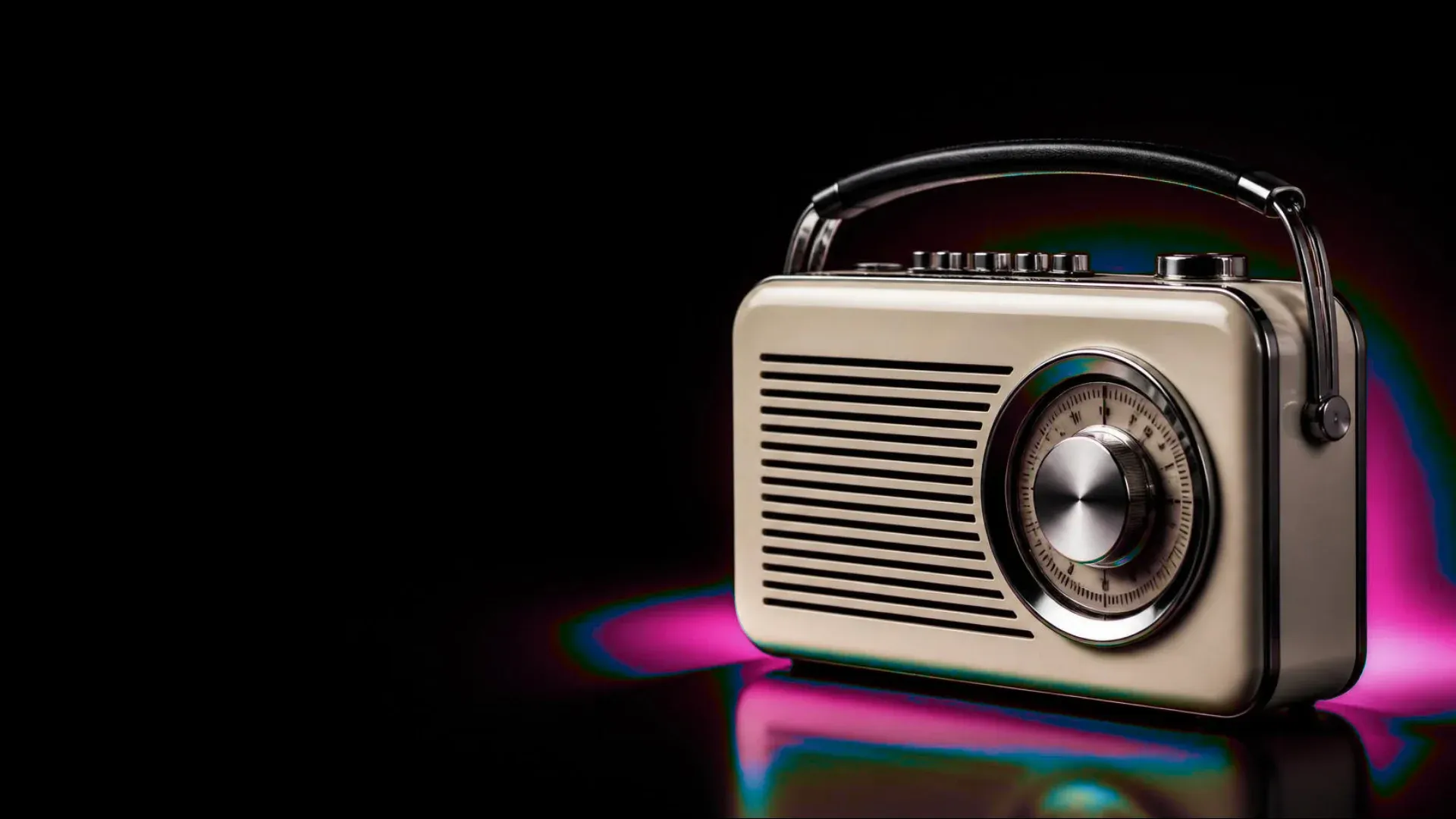 A cream vintage radio with a large chrome dial, against a black background in a pink glow