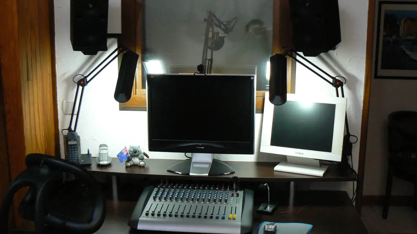 The first home studio’s control room: two screens, mixing desk and window into the booth