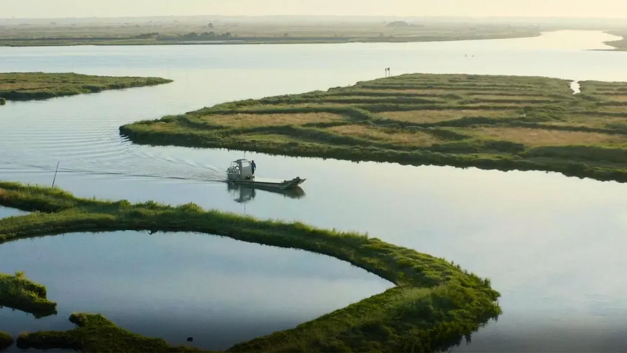 Vue aérienne d’une côte découpée, un bateau sur l’eau calme